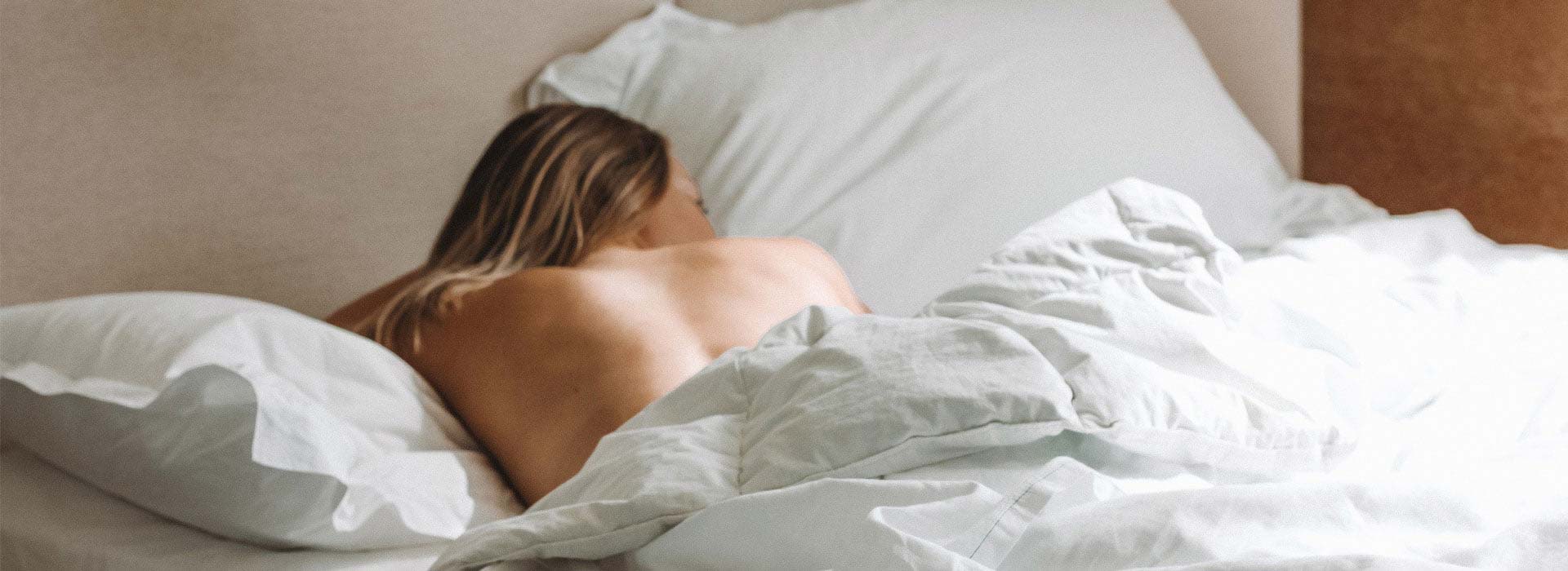 Woman laying in bed after taking a CBD Oil Tincture