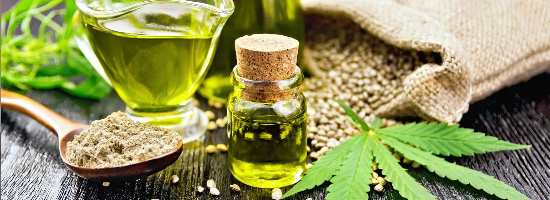 CBD Oil Vial with raw Hemp Seeds and Marijuana Leafs